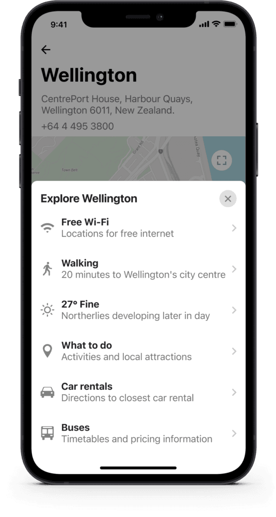 Smartphone screen showing an overlay menu with Wellington visitor services including Wi-Fi, walking tours, and transport options.
