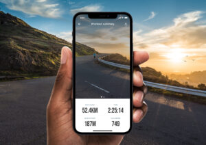Hand holding an iPhone showing a workout summary screen with stats for distance, time, elevation, and calories.