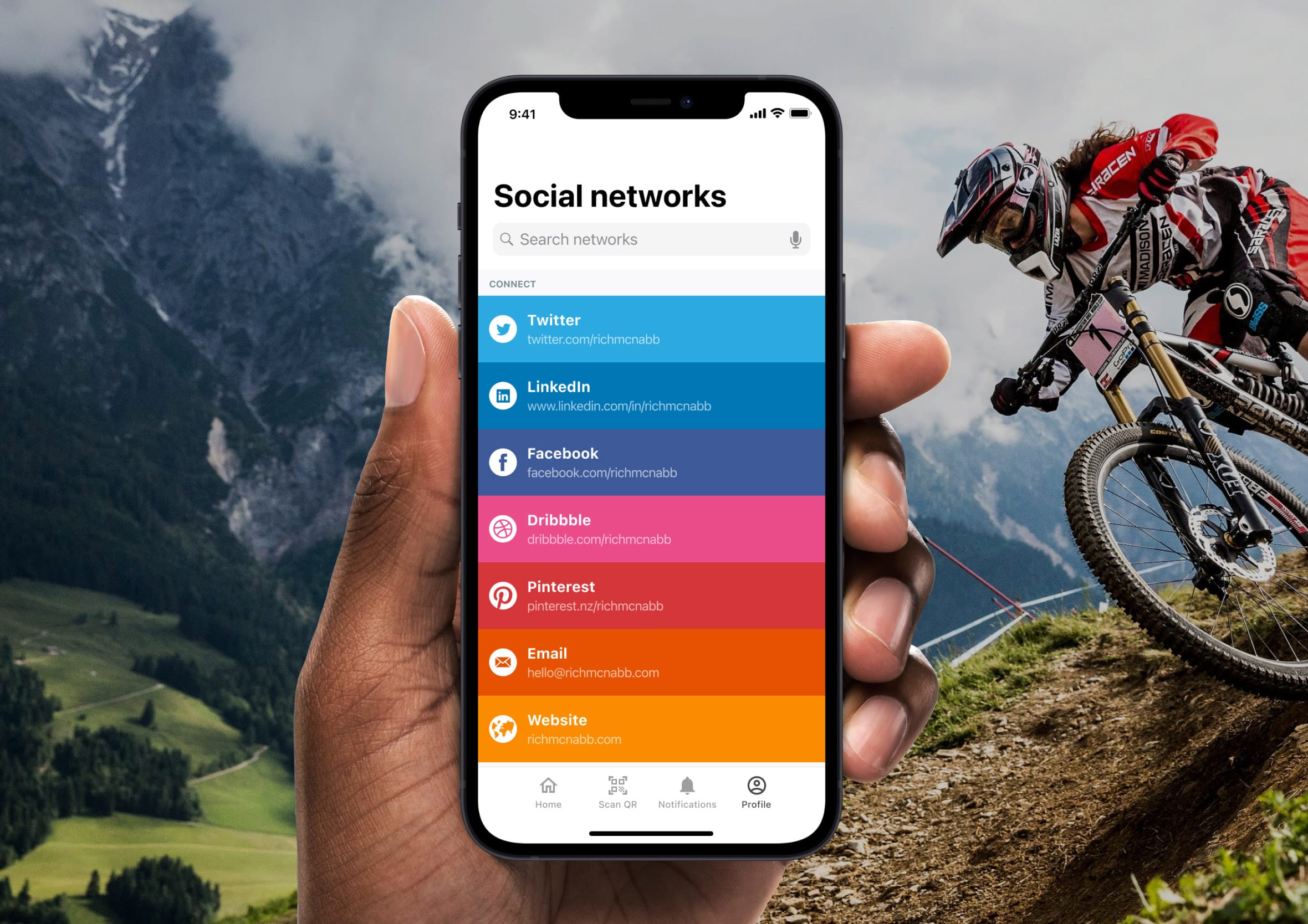 Hand holding an iPhone displaying a colourful list of social network contact links.