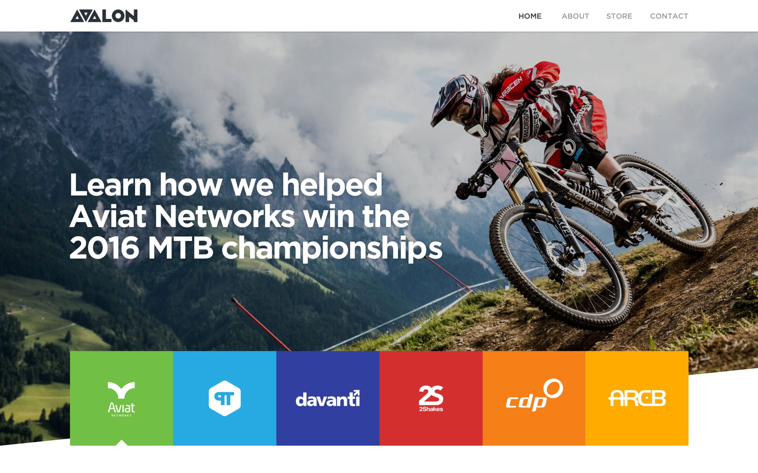 Website homepage header with top navigation bar and a background banner image of a mountain biker.