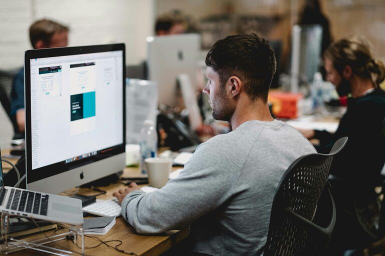 Person working at a desk in a creative studio environment