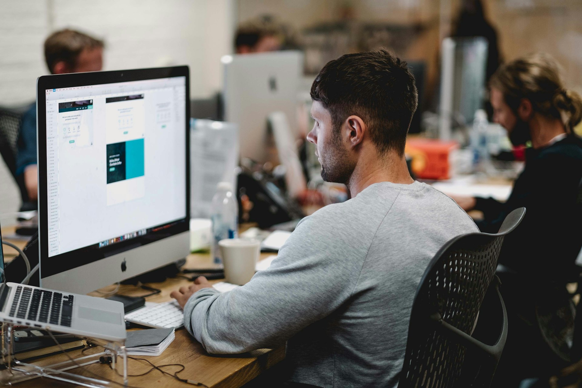 Person working at a desk in a creative studio environment