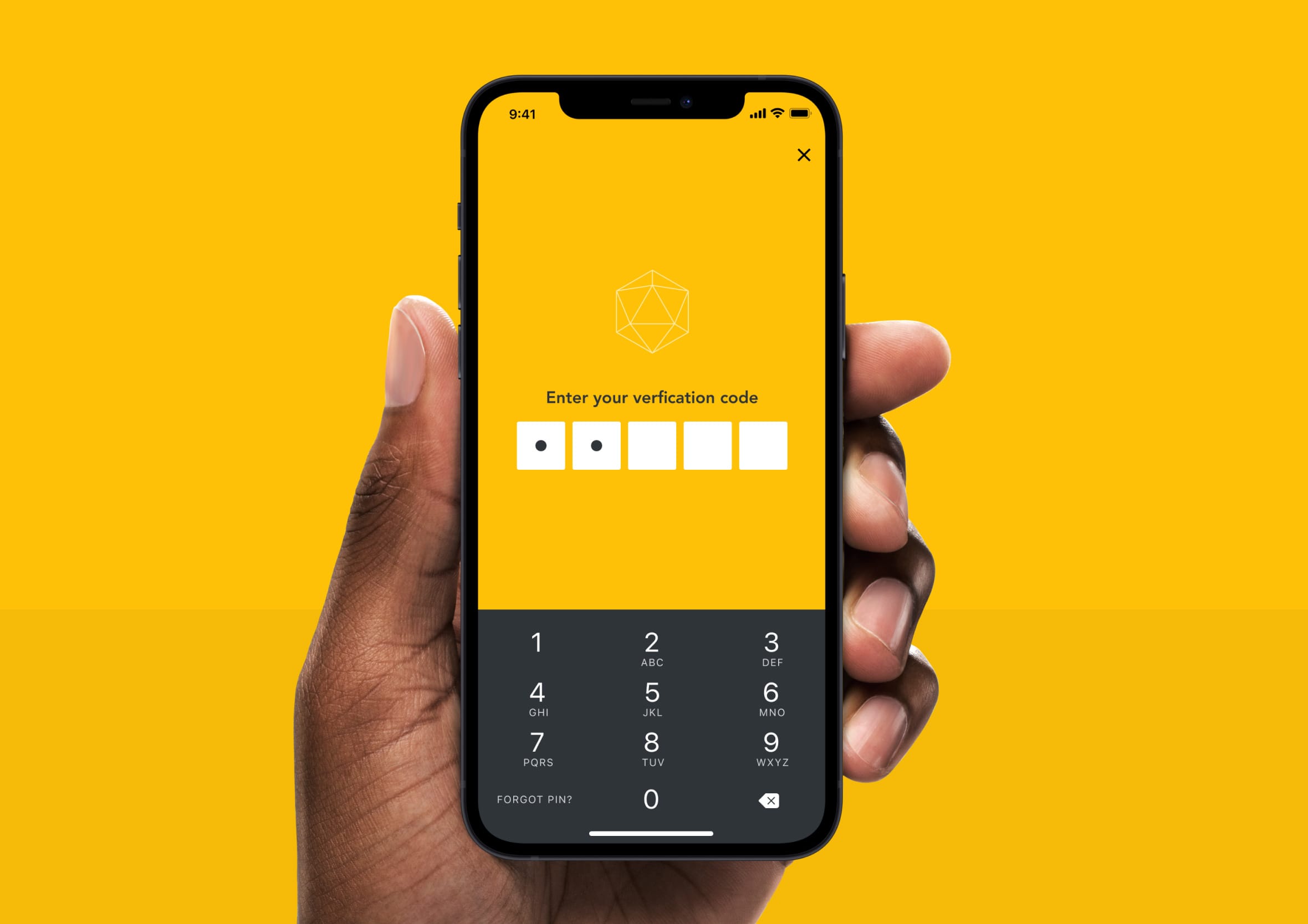 Hand holding a black iPhone showing a yellow-themed verification code entry screen with a keypad.