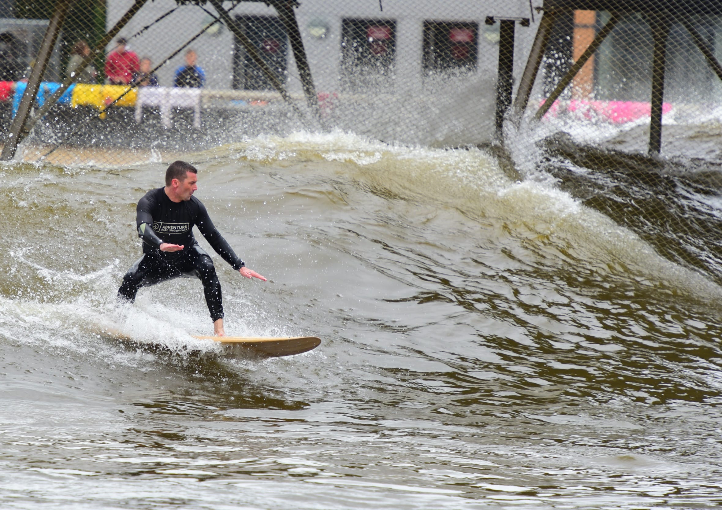 Surfing on an inland artificial wave at Adventure Parc Snowdonia in Wales