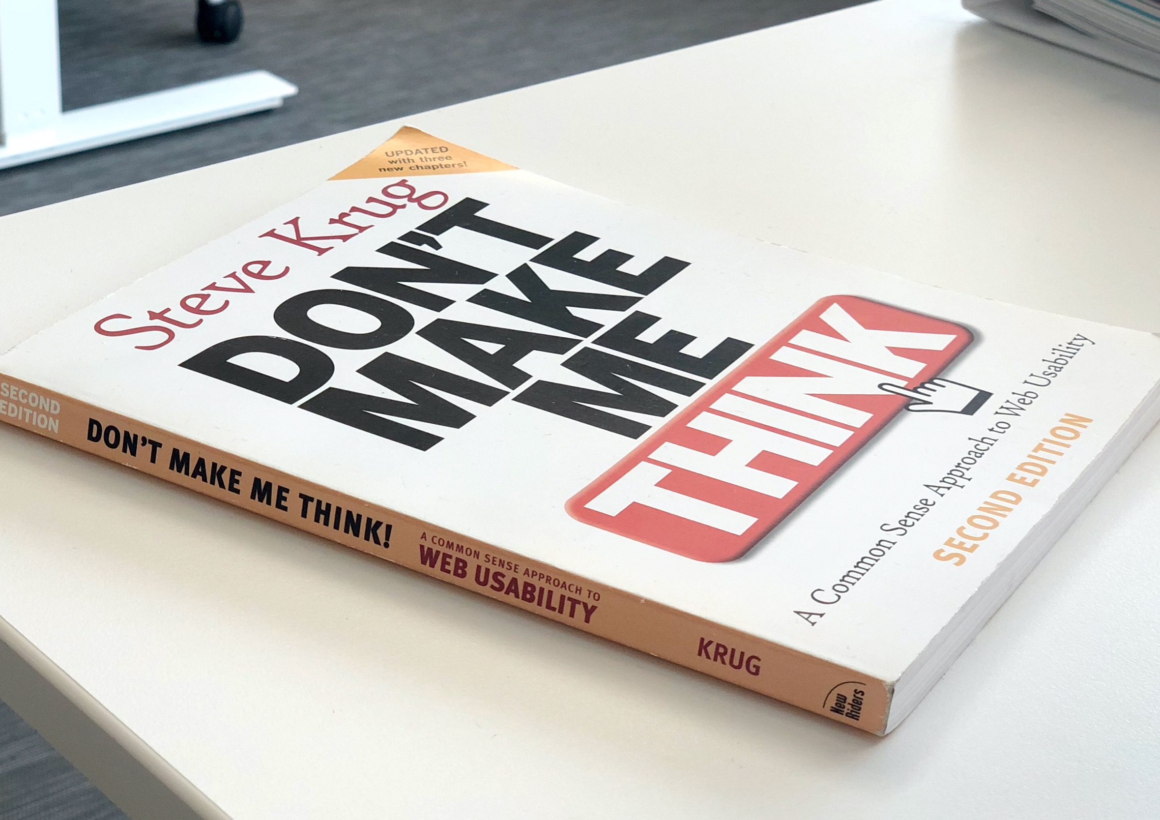 Angled perspective view of the second edition of Don't Make Me Think! by Steve Krug resting on a desk.