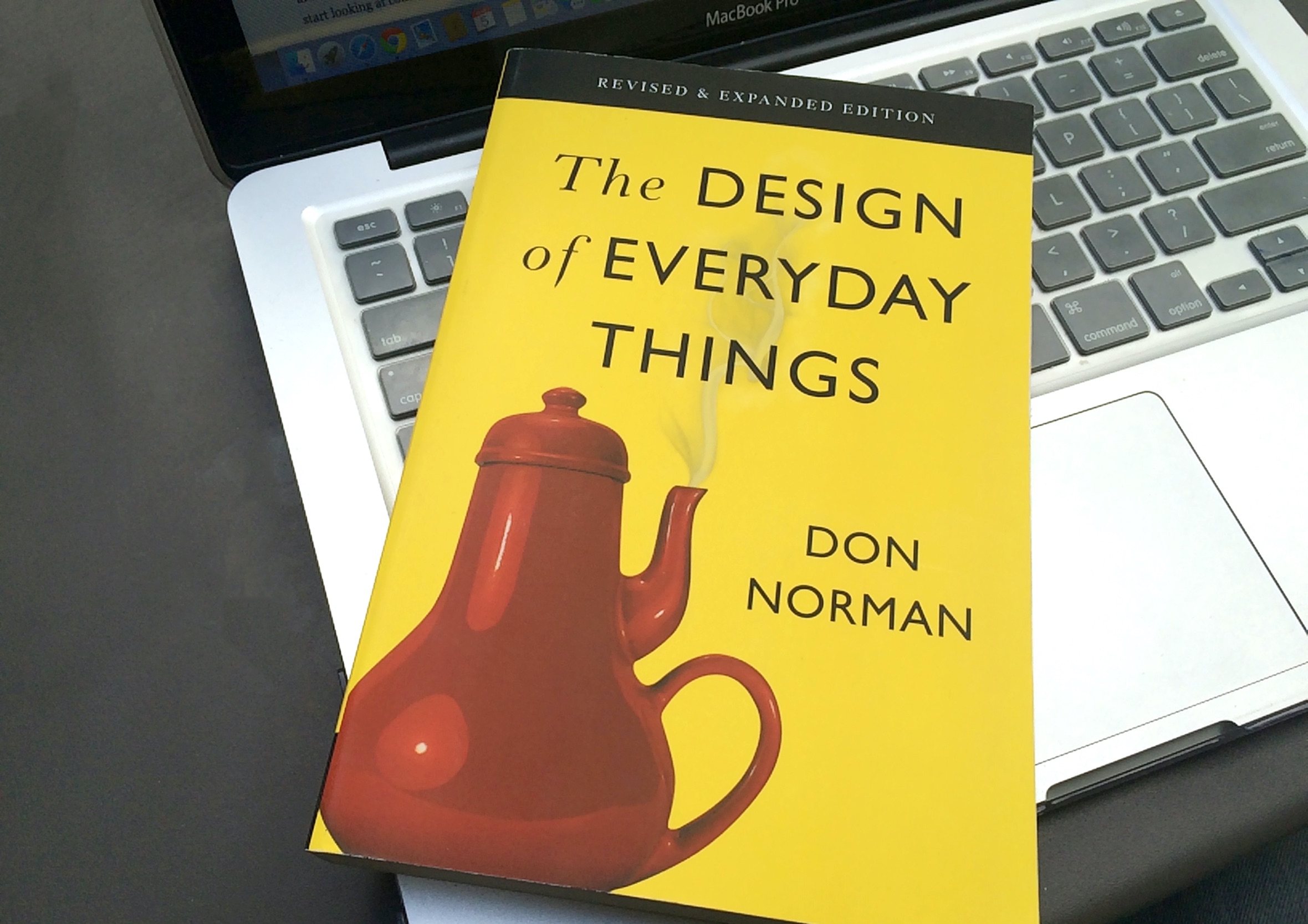 Front cover of The Design of Everyday Things by Don Norman resting on an open laptop keyboard.