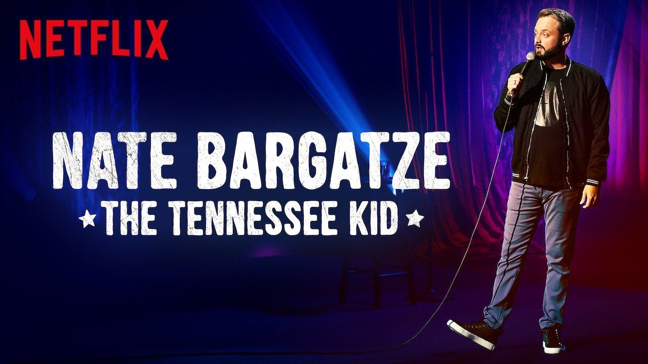 Title graphic for Nate Bargatze's stand-up comedy special The Tennessee Kid showing Bargatze on a dark stage backdrop.