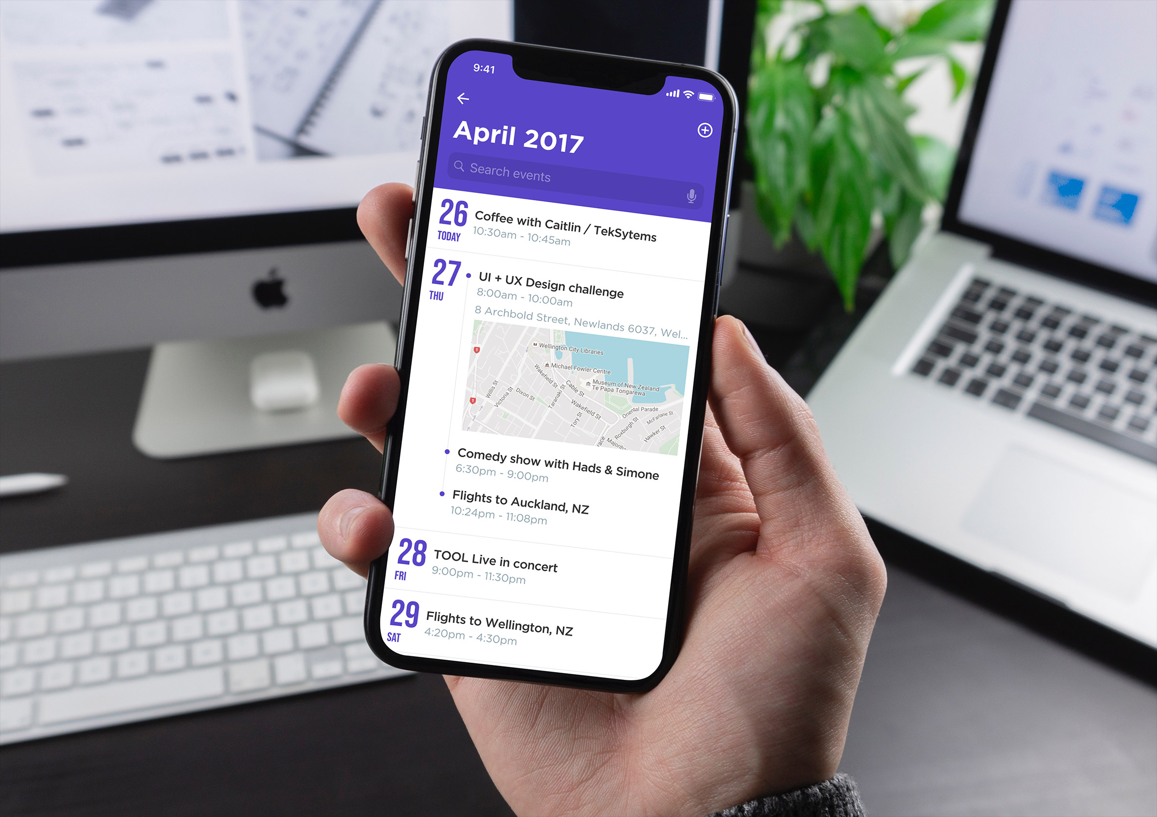 Hand holding an iPhone showing a calendar schedule app with upcoming events and a map inset.