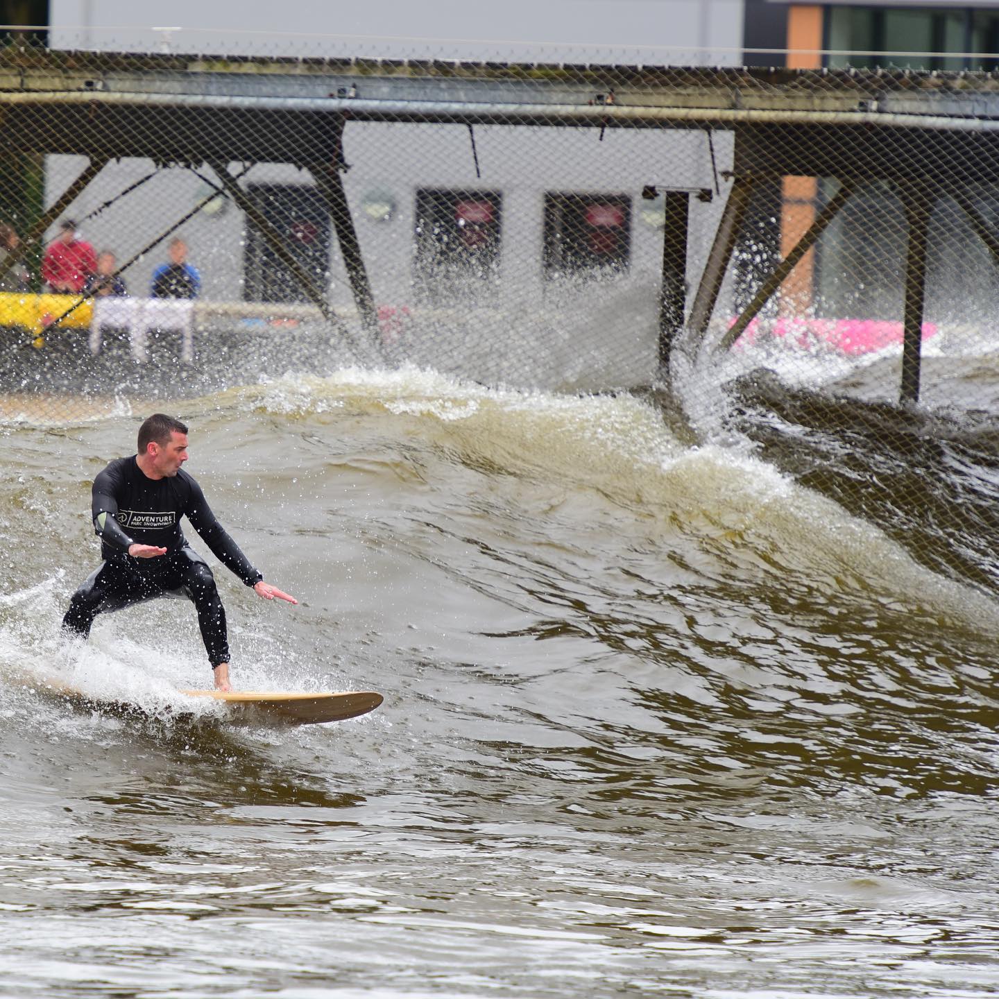 Rich surfing the artificial wave pool at Surf Snowdonia in Wales