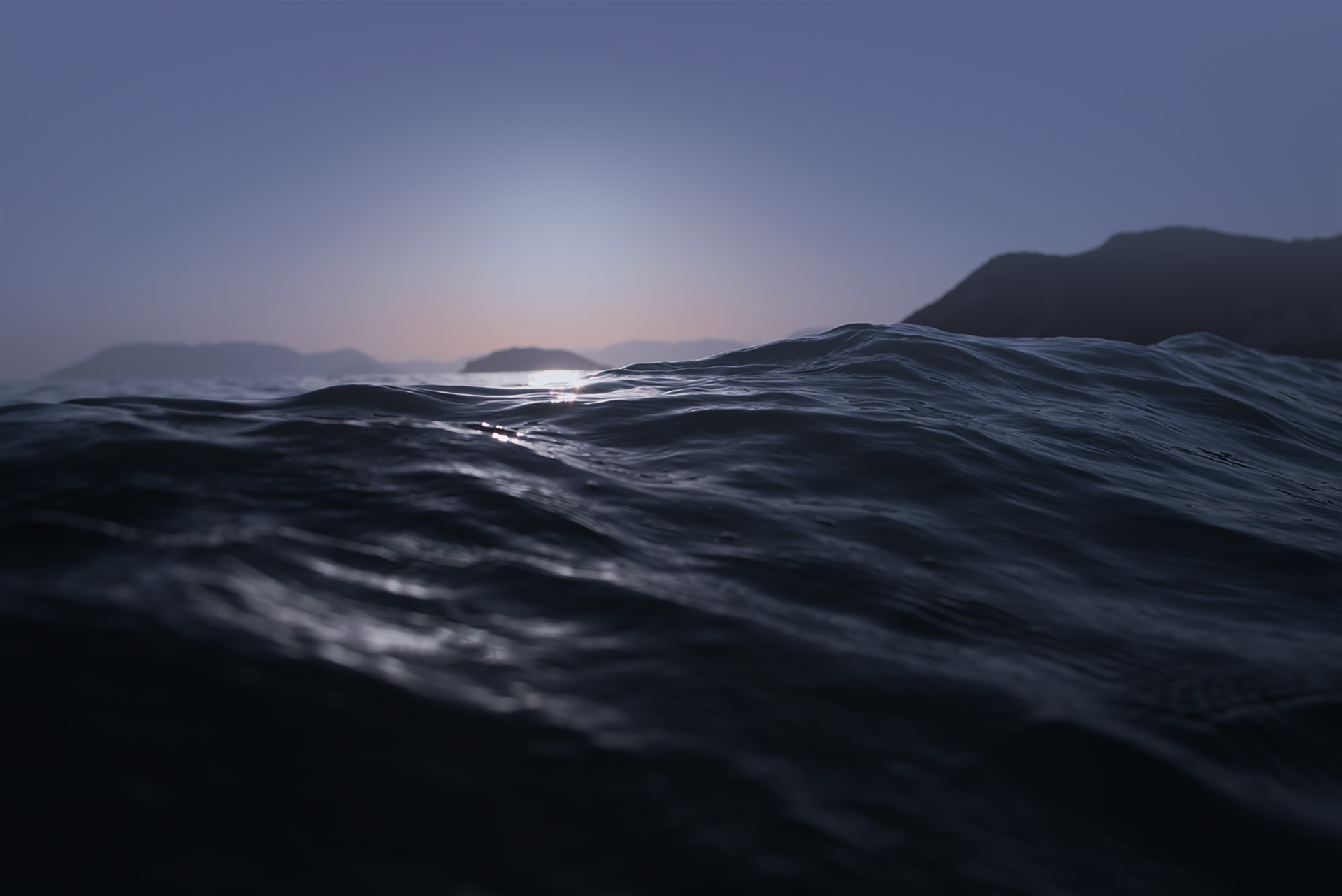 Ocean wave close-up with sunlight reflecting on the water surface and distant hills at dusk, showcasing natural beauty for digital product design inspiration.
