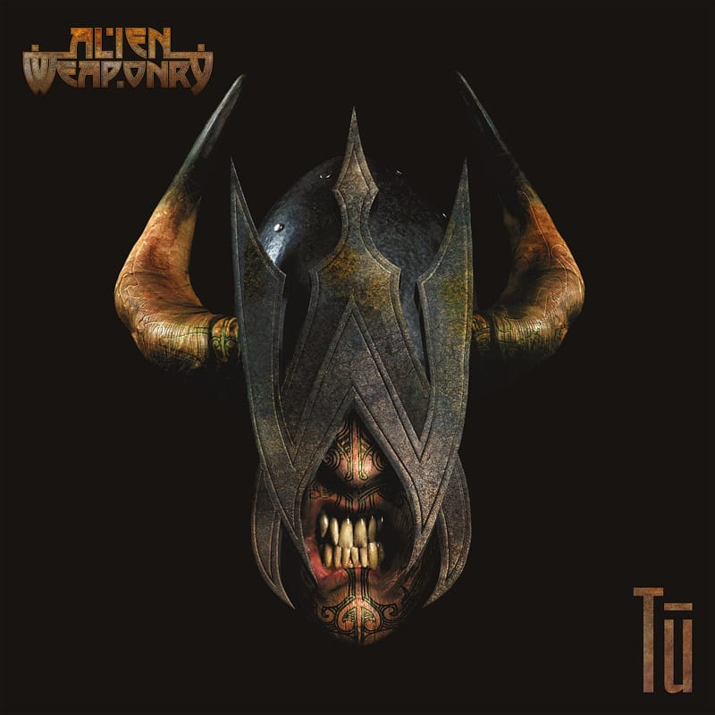 Cover artwork for Alien Weaponry's album Tū, featuring a golden bronze bull head carved with traditional Maori patterns.