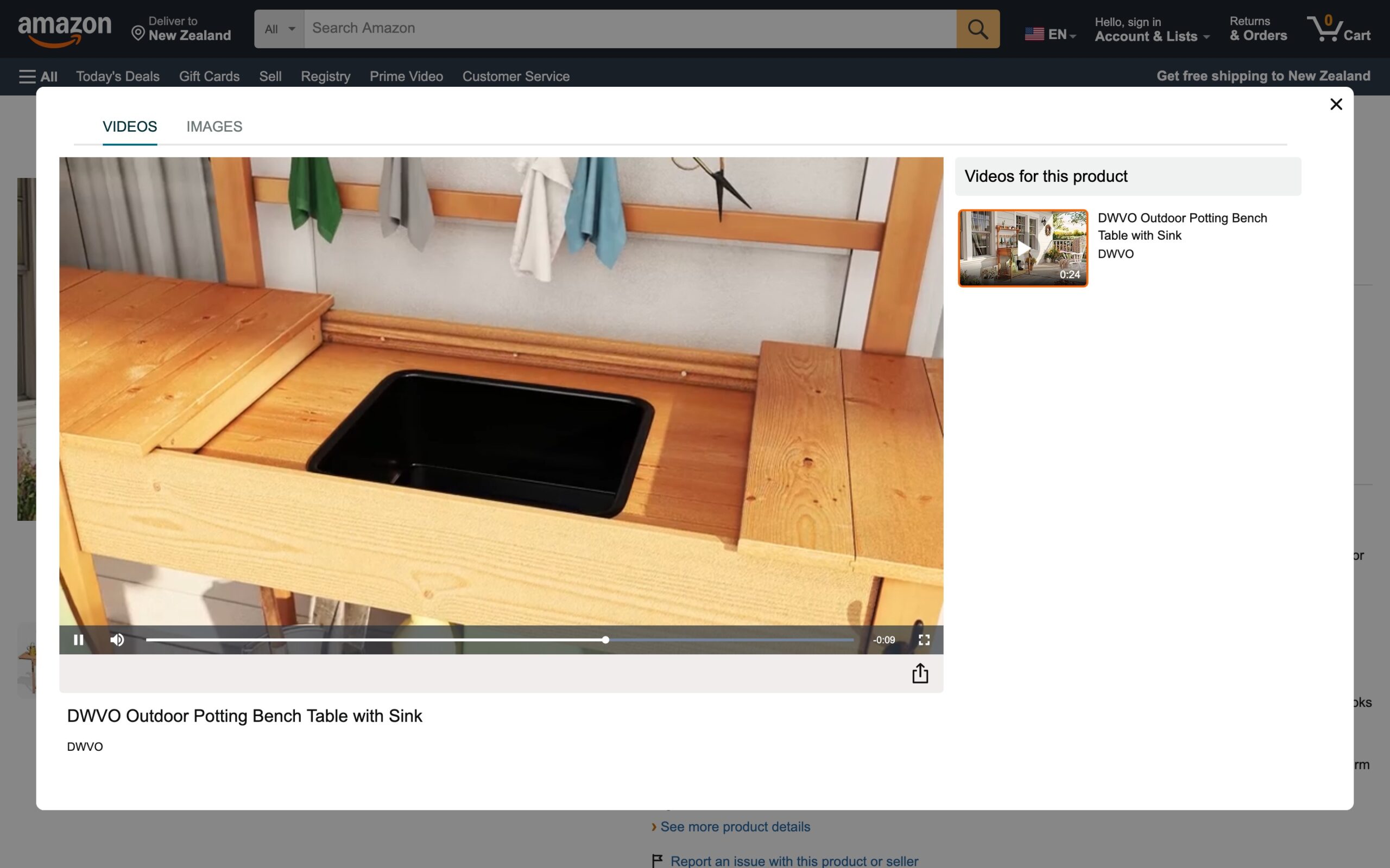 Video player frame from an Amazon product listing showing the DWVO potting bench top fully extended to reveal the recessed black plastic sink container.