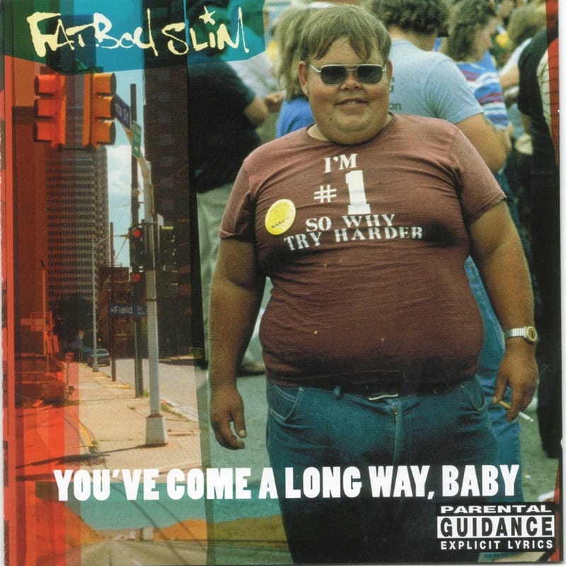 Album visual for Fatboy Slim's You've Come A Long Way, Baby, showing an overweight man wearing a t-shirt that reads "I'm #1 So Why Try Harder".