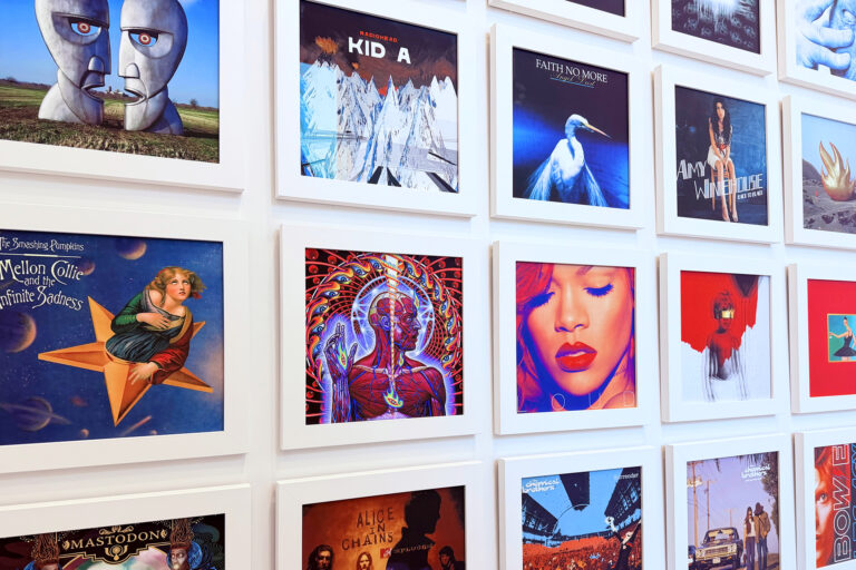 Grid view of framed iconic album artwork on a white wall displaying covers from Radiohead and Amy Winehouse, reflecting a passion for music culture and graphic design inspiration.