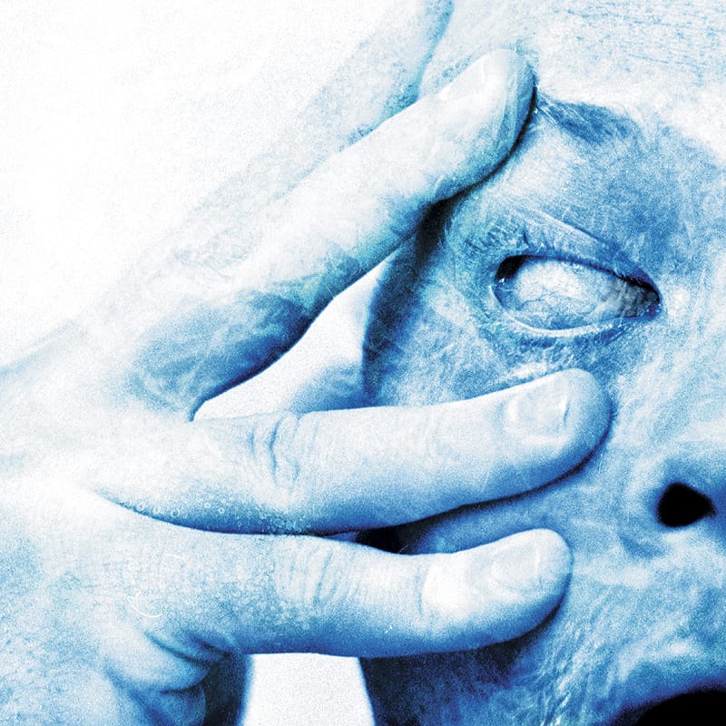 Distorted portrait photography for Porcupine Tree's In Absentia, showing a person holding their face in despair.