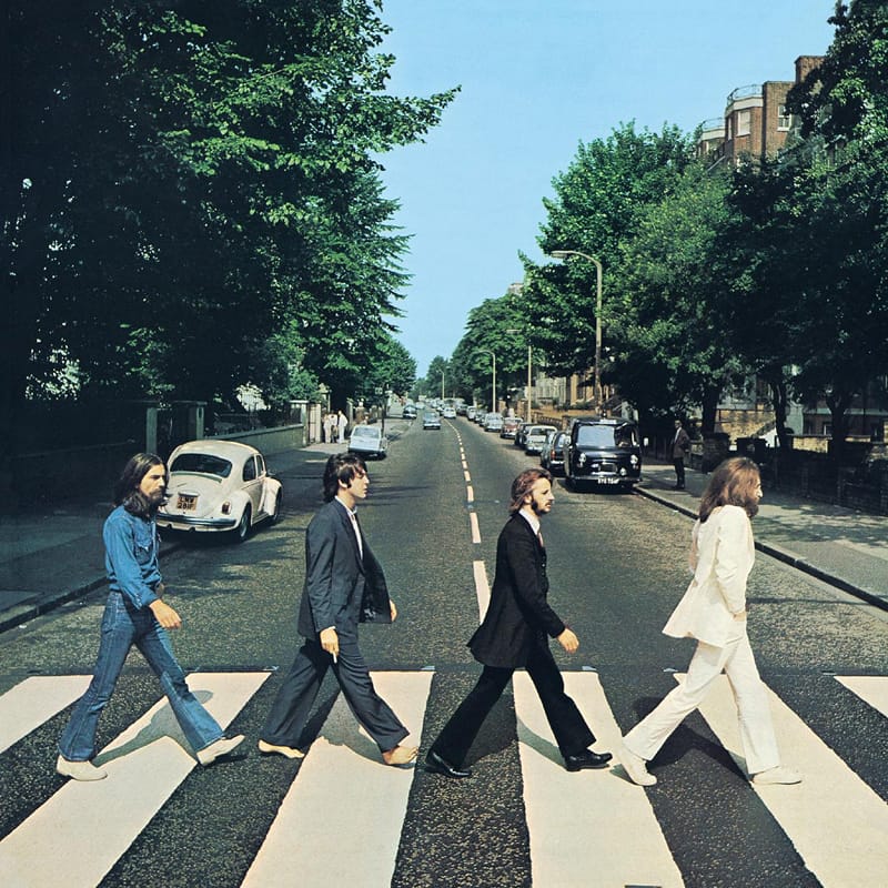 Legendary crosswalk photograph for The Beatles' Abbey Road, showing the band members walking across a pedestrian zebra crossing.