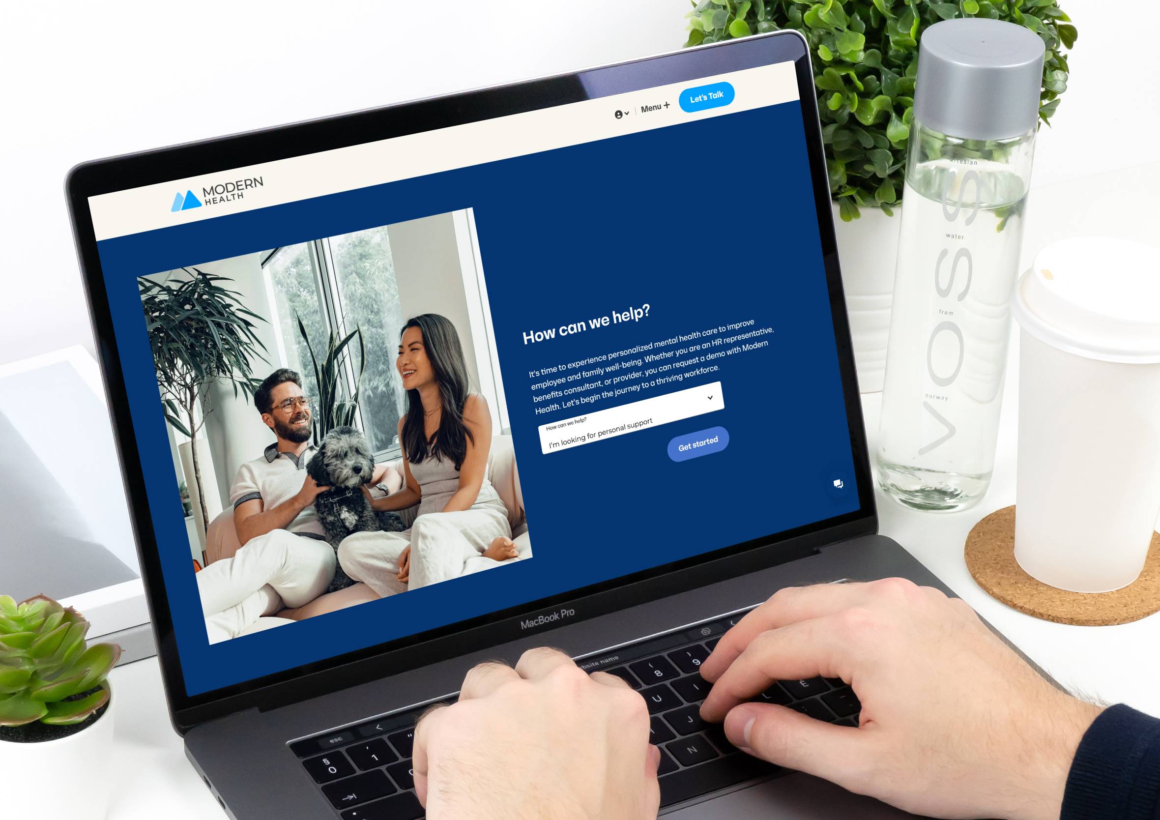 Laptop screen displaying the Modern Health website homepage with a "How can we help?" dropdown.