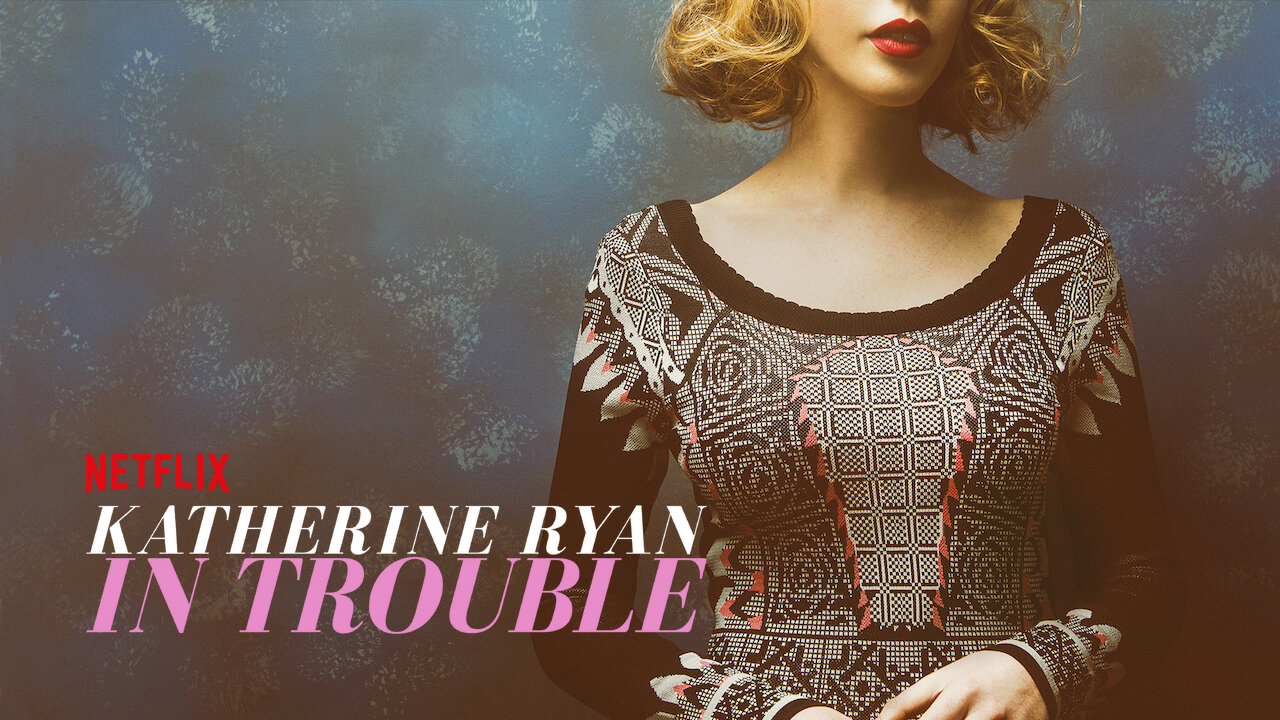 Title card for Katherine Ryan's stand-up comedy special In Trouble featuring Ryan in a patterned top.