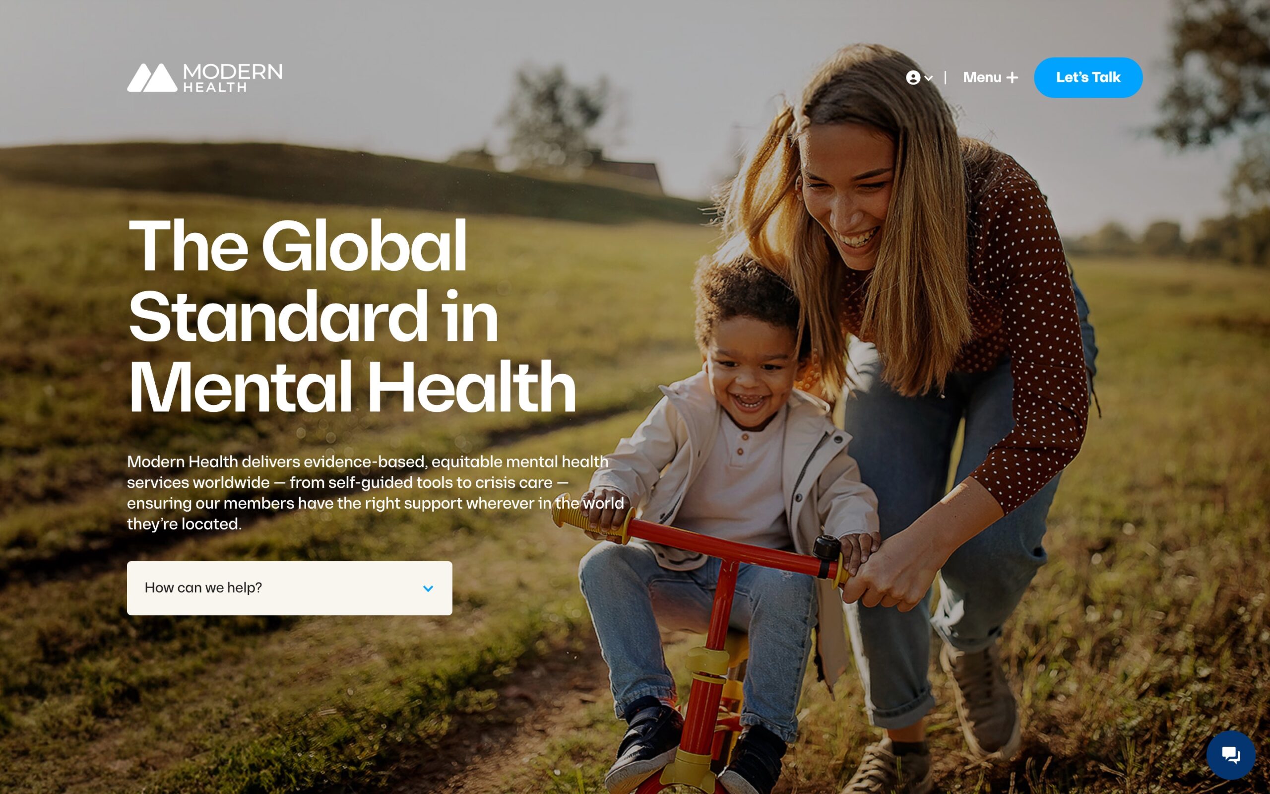Modern Health homepage showing a woman playing with a child on a tricycle outdoors.