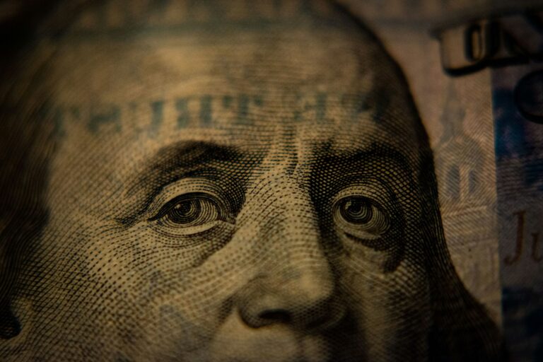 Extreme macro close-up of Benjamin Franklin's eyes on a United States 100-dollar bill.