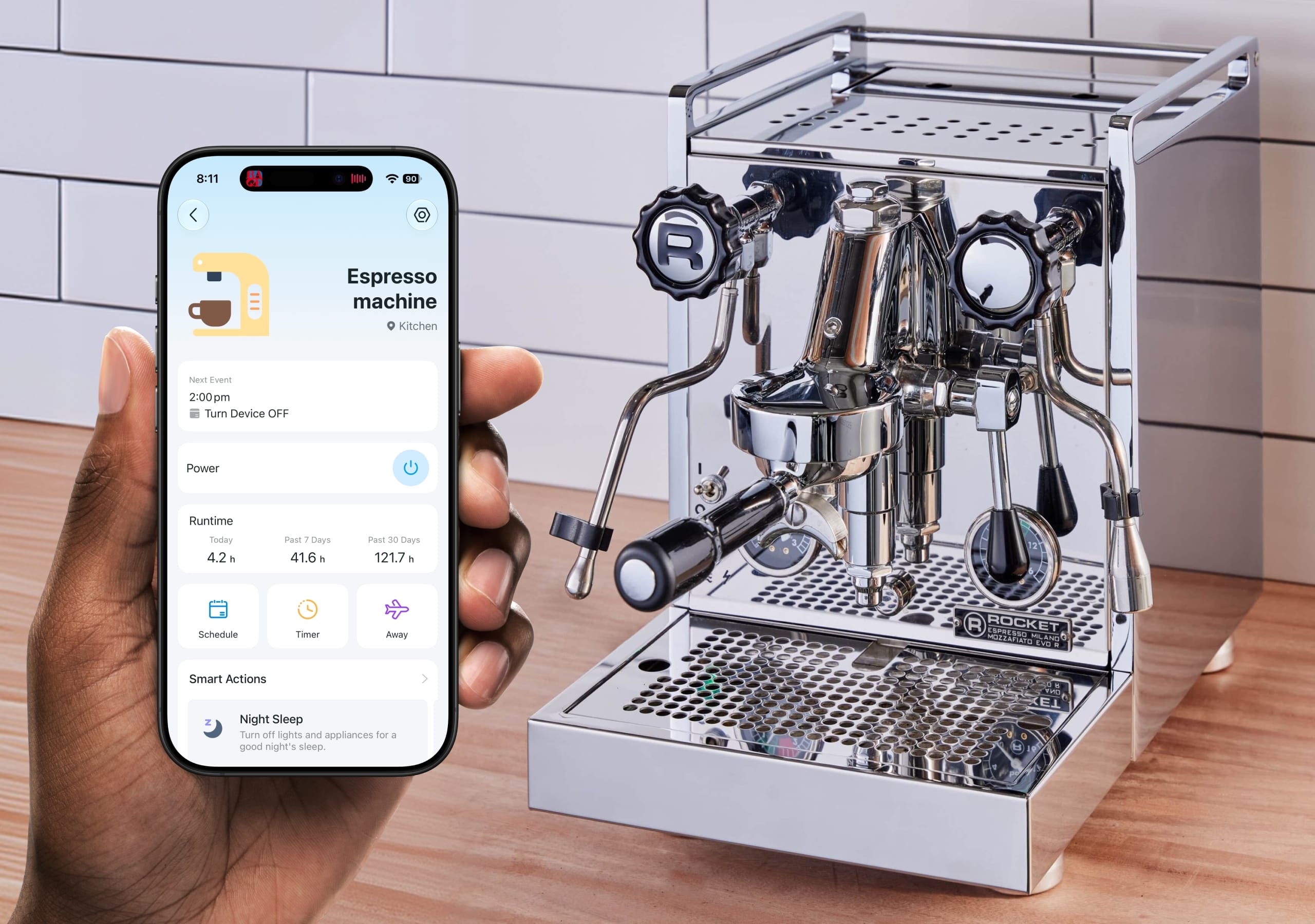 Hand holding a smartphone showing a smart plug app screen next to a stainless steel Rocket Mozzafiato espresso machine.