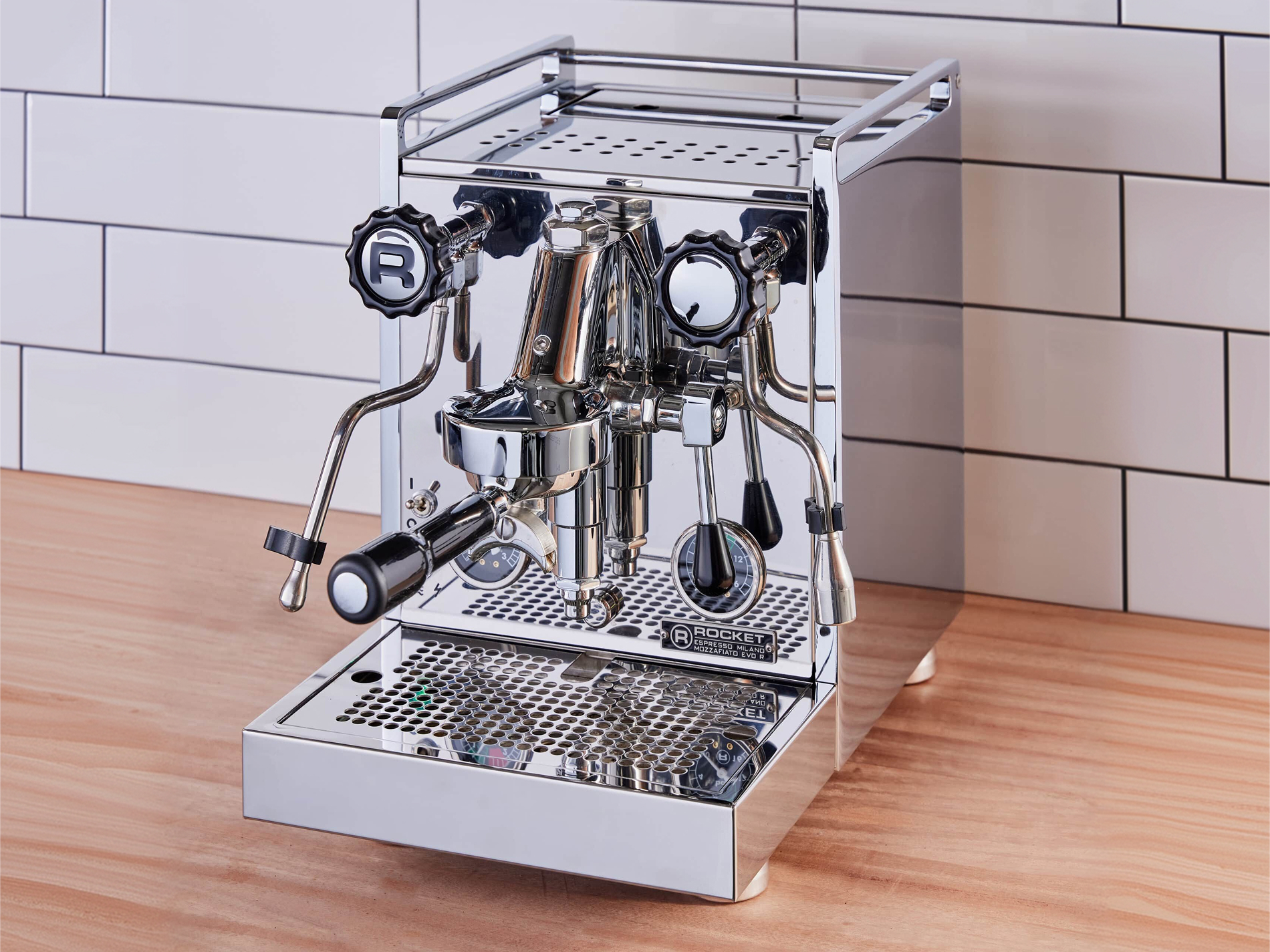 A polished stainless steel Rocket Mozzafiato Evoluzione R espresso machine on a kitchen bench.