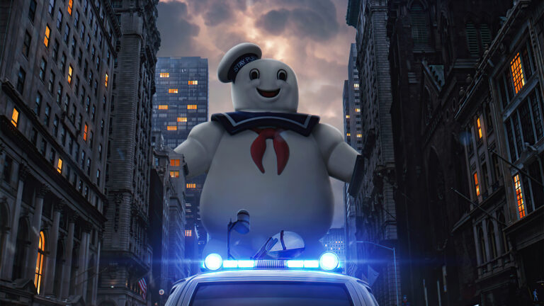 The Stay Puft Marshmallow Man towering over a city street at night, from Ghostbusters.